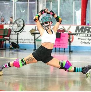Melina Rose doing the Melina Splits at roller derby, her face is painted as a skeleton. She is using our Flash Lightning Ceramic Bearings