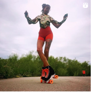 Deesh is standing with her skates crossed over. She is using our flash lightning ceramic bearings in red.